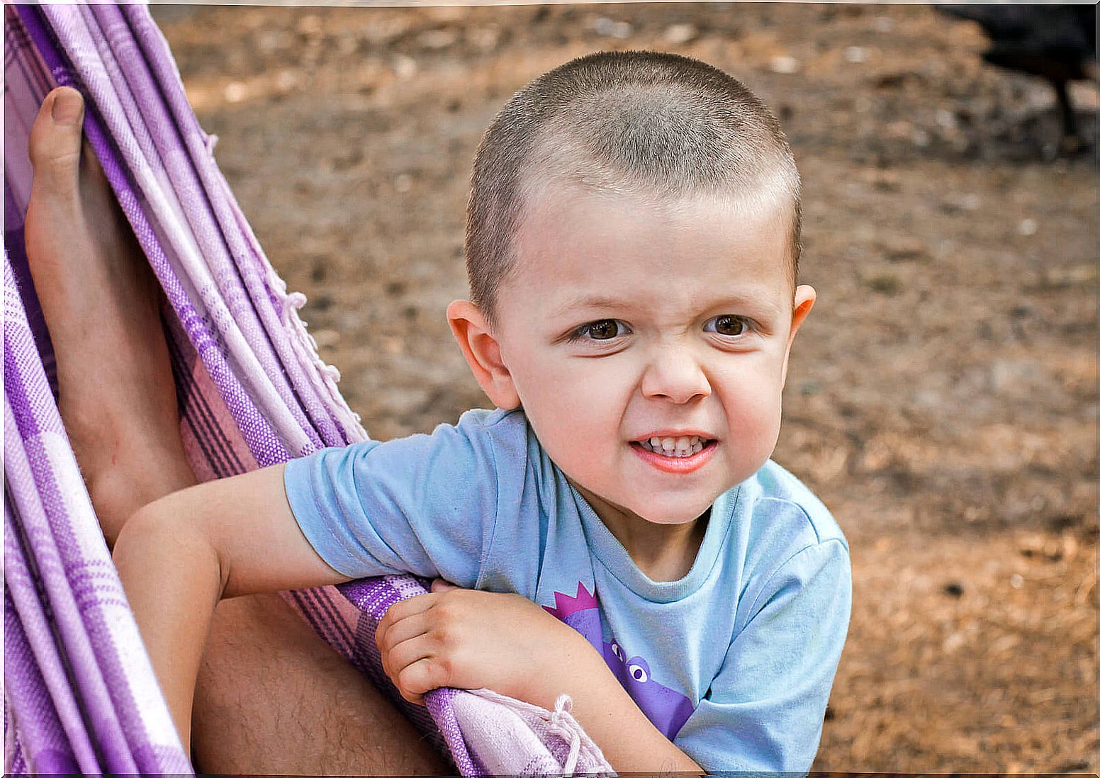 Boy teasing his father while taking a nap and having a stubborn attitude.