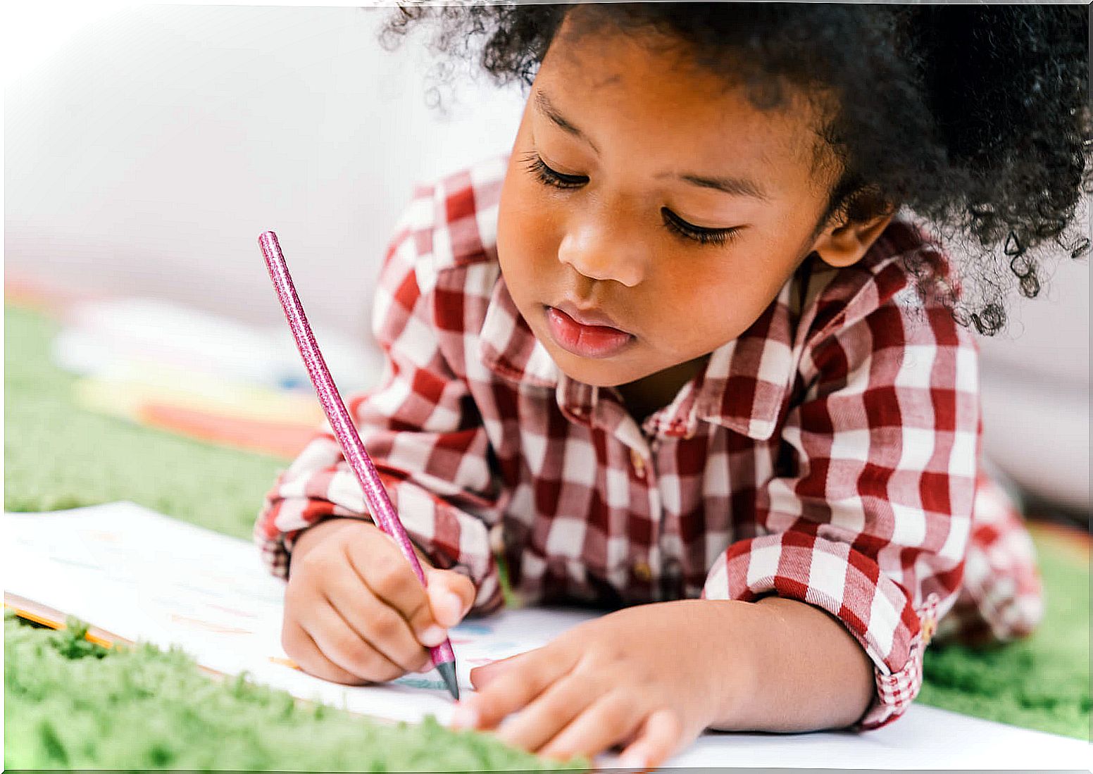 Very smart girl writing at an early age.