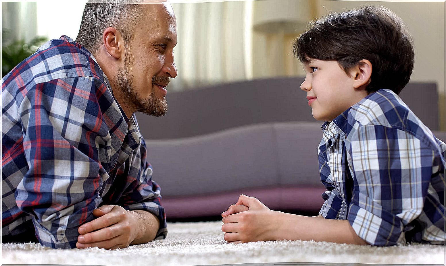 Father talking to his son using educational alternatives instead of banning.