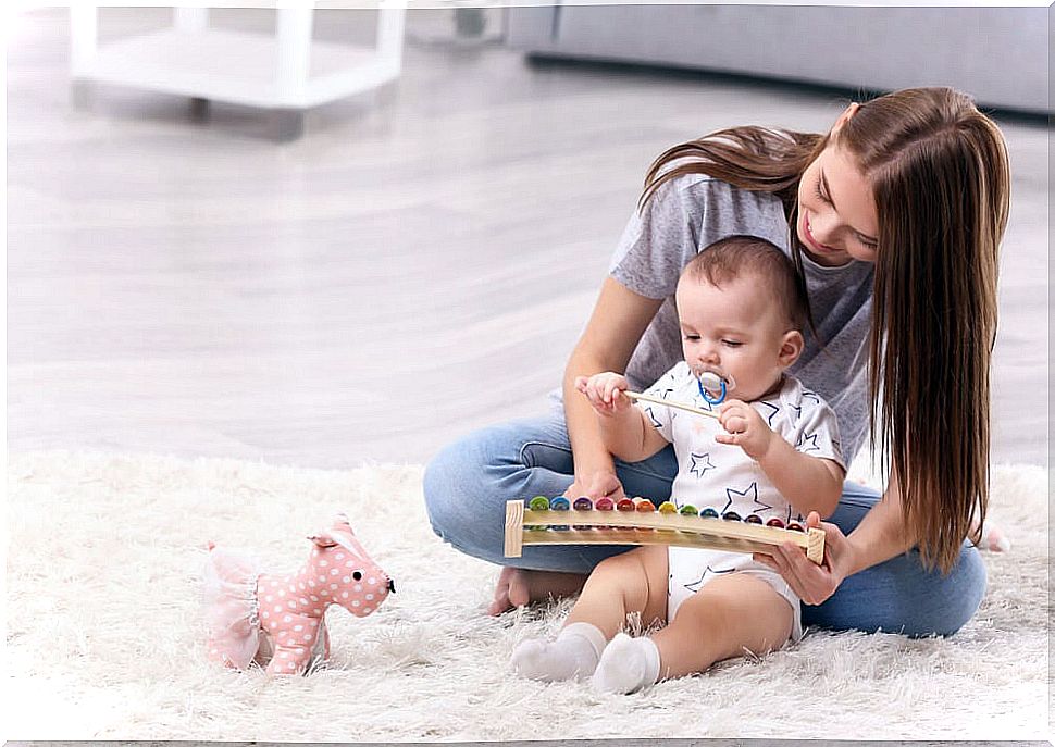 Mom playing with her baby and doing exercises for his development.