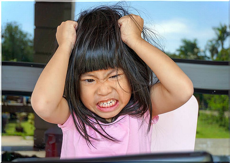 Angry girl pulling her hair.