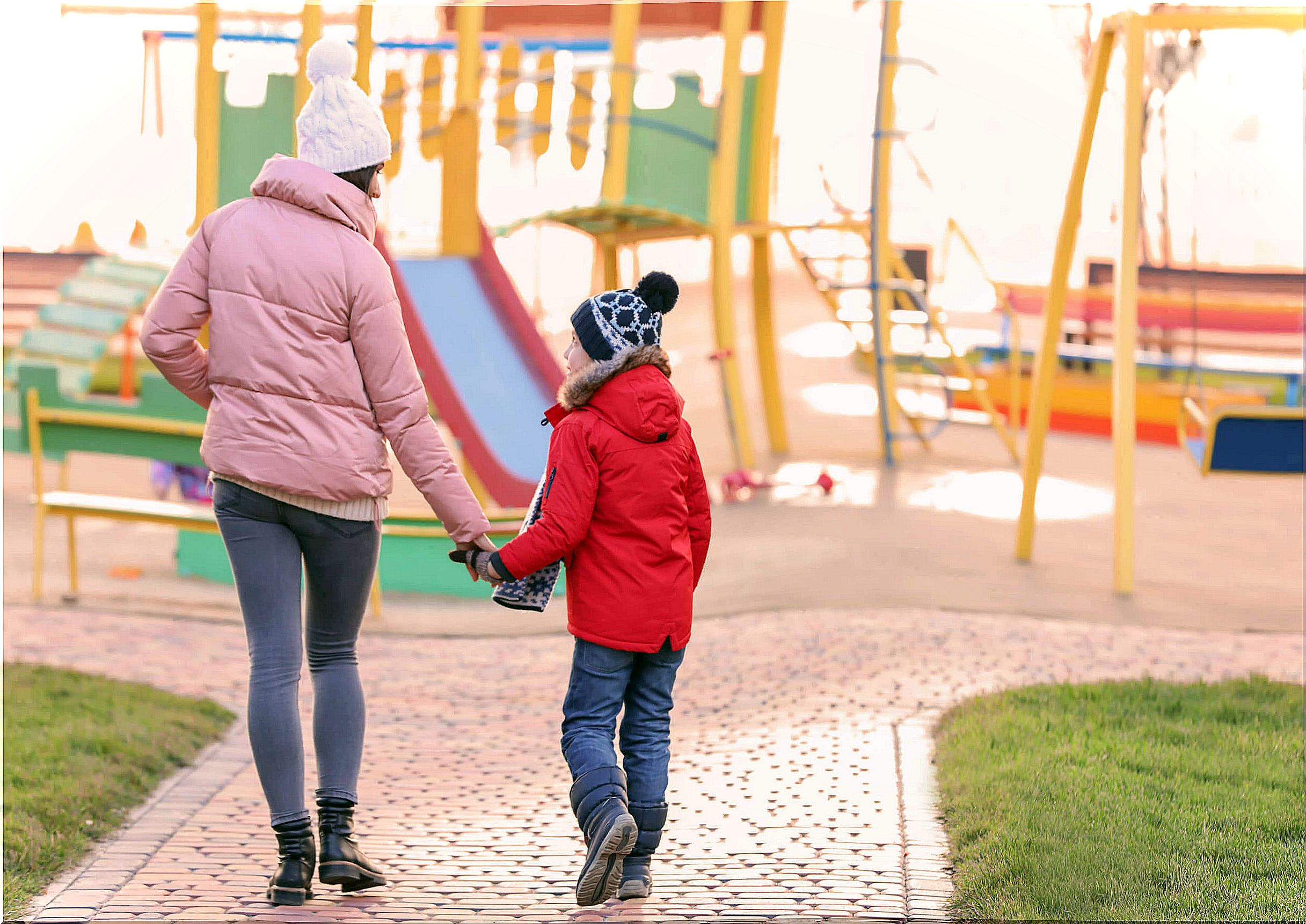 Mother taking a walk in the park with her adopted son.