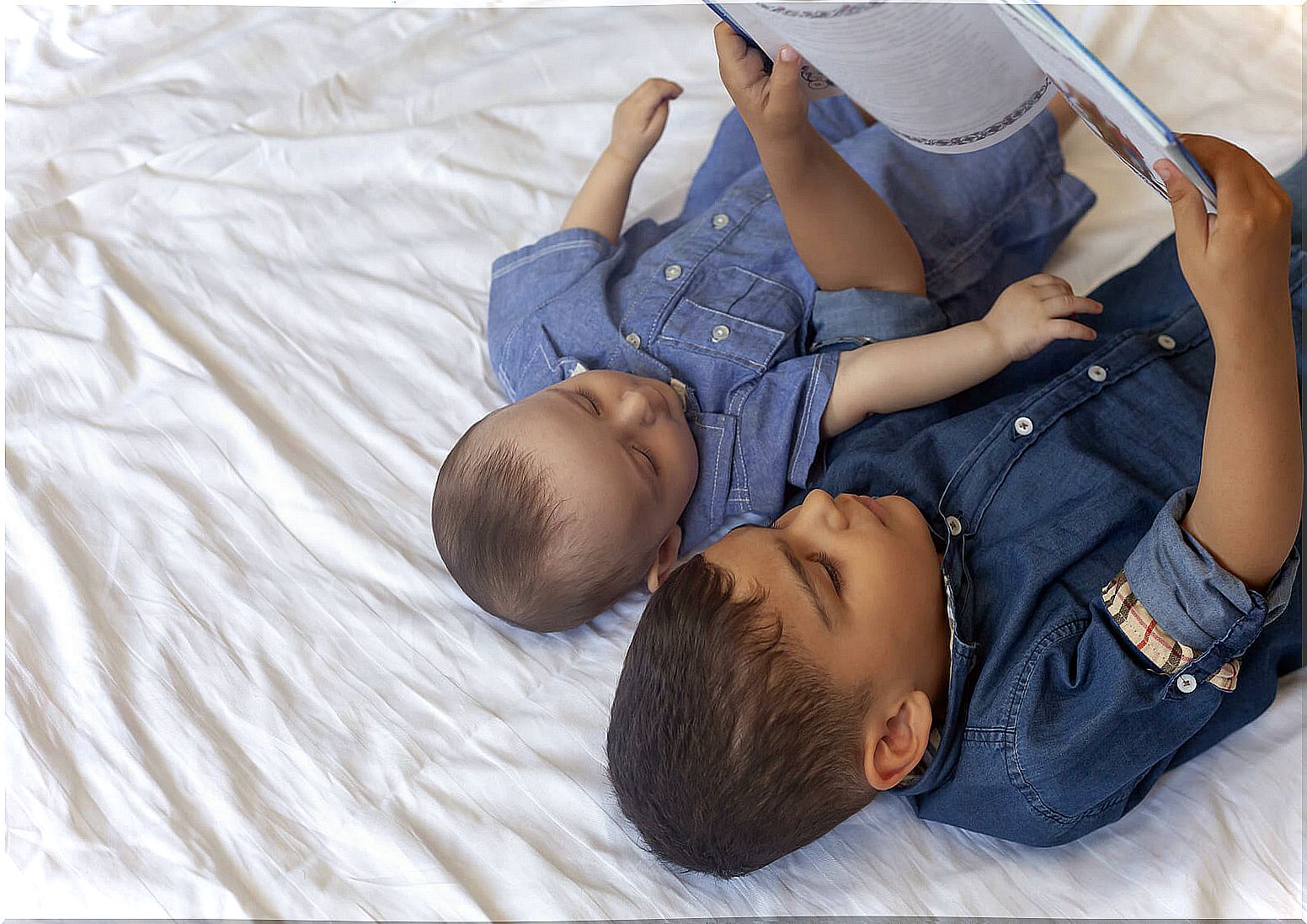 Brothers reading stories to combat the overload of the older brother.