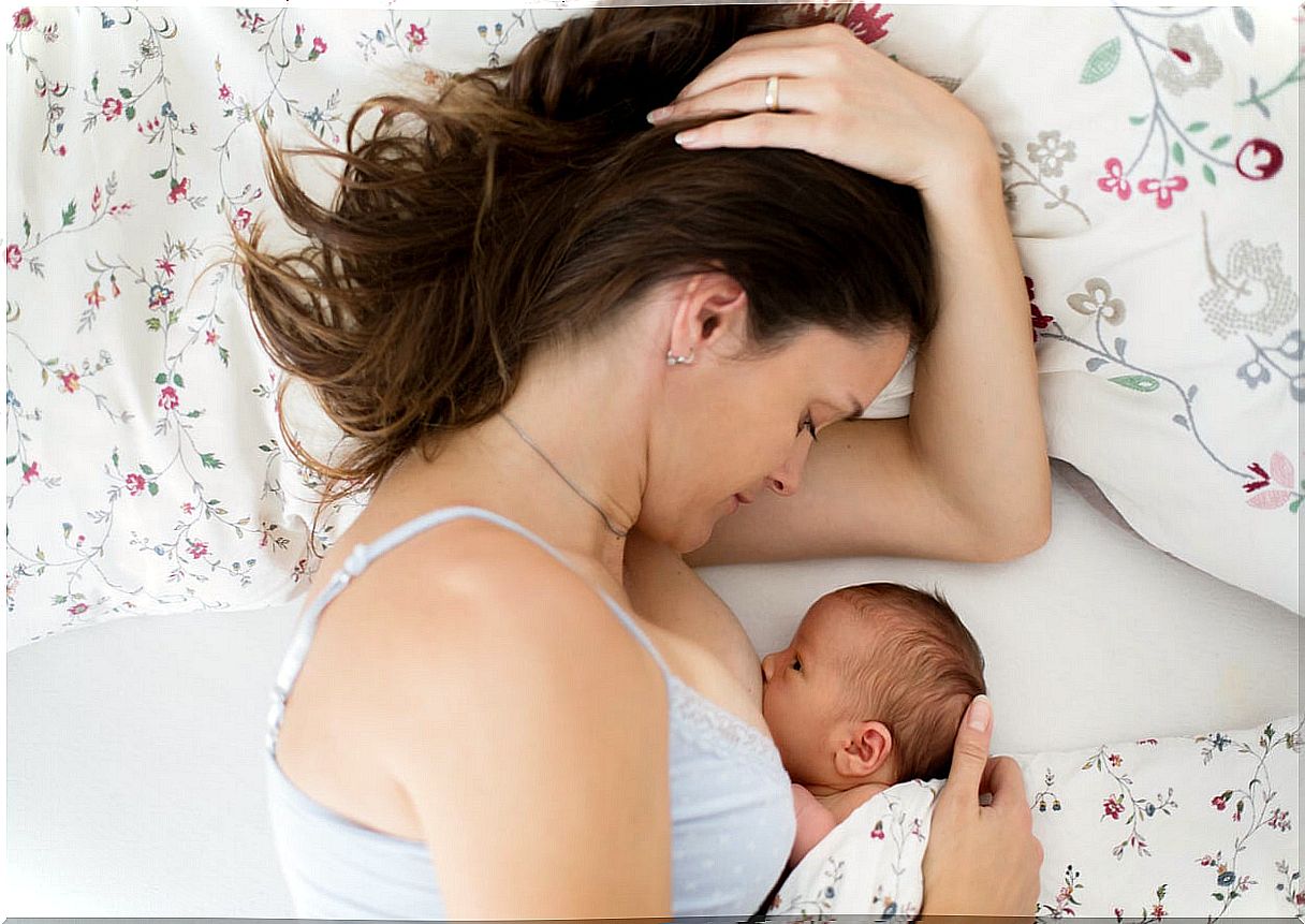 Mom cuddling with her newborn baby.