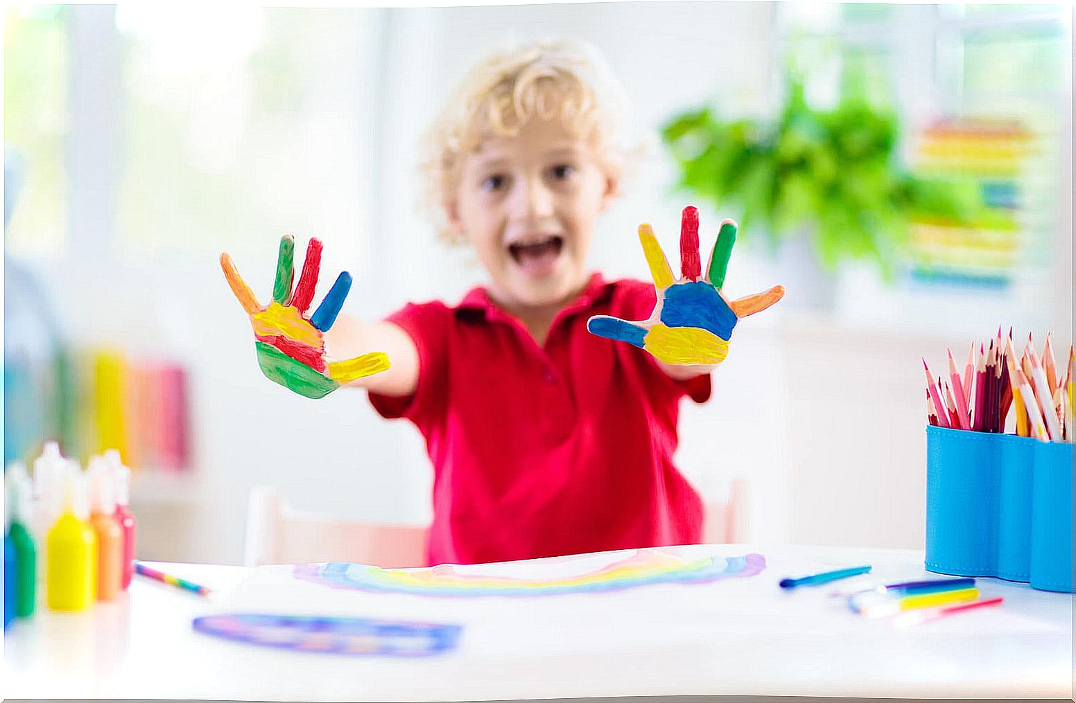 Child playing finger painting.