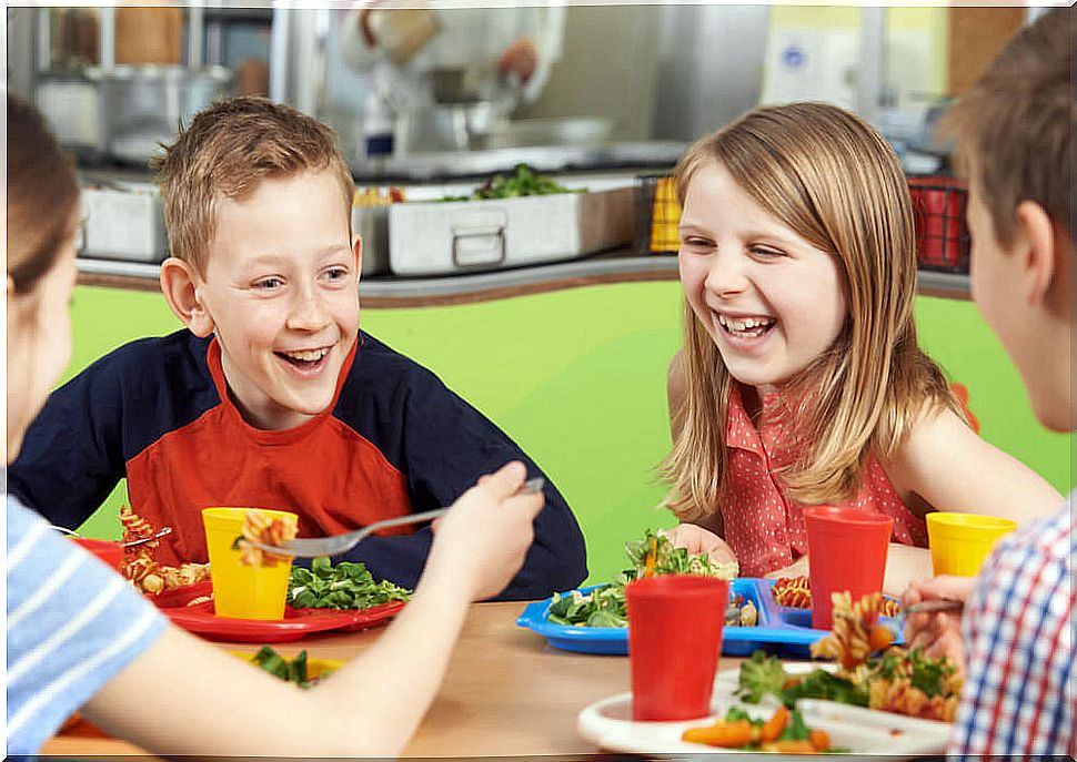 Children enjoying a meal in the school cafeteria.