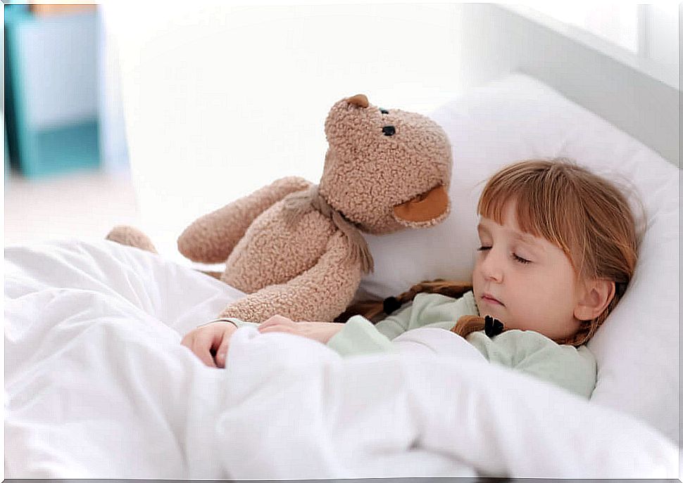 Little girl sleeping with her teddy bear.