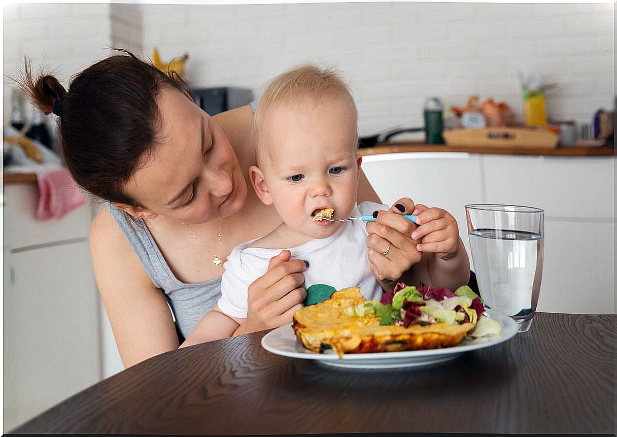 Mother feeding her 12 month old baby.