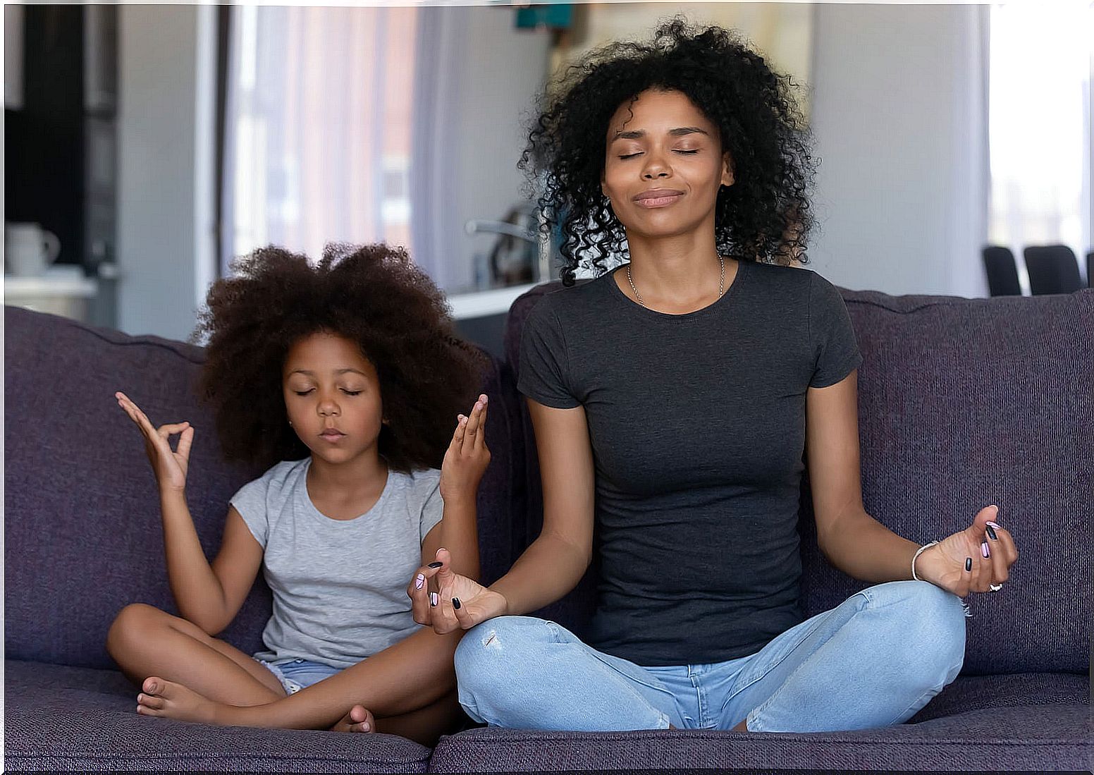 Mother and daughter practicing mindfulness.