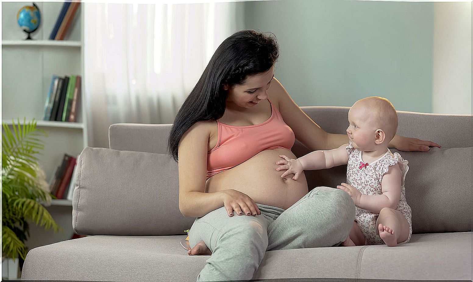 Mom telling her daughter that she is going to have a baby brother.