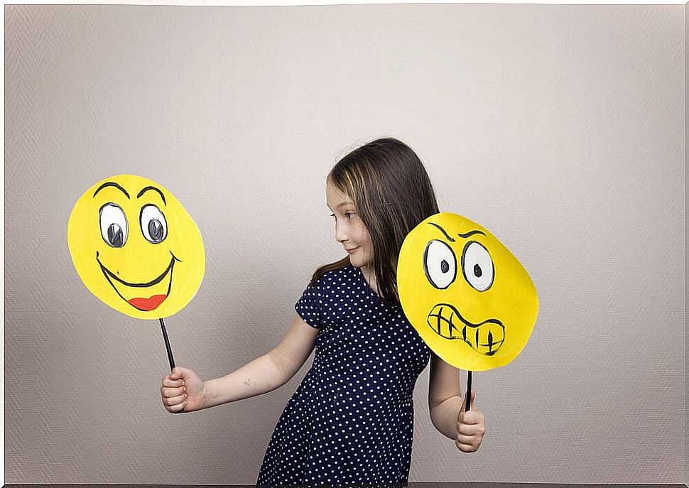 Girl with yellow faces drawn representing emotions.