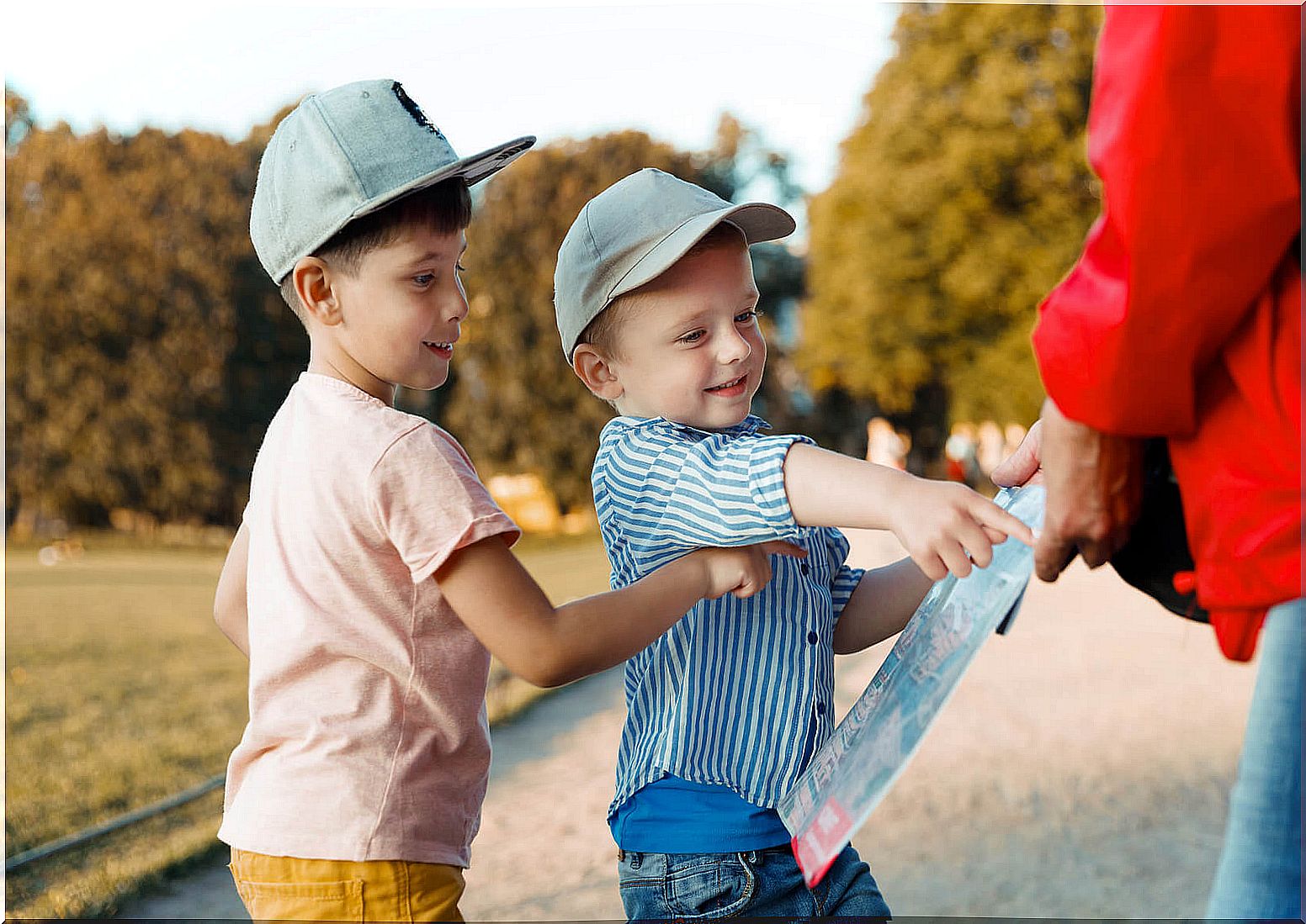 Children consulting a map in the city