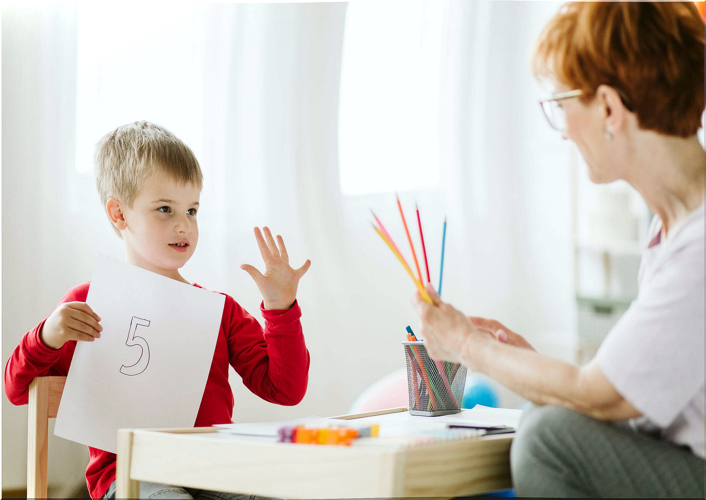 Child with his teacher for support.