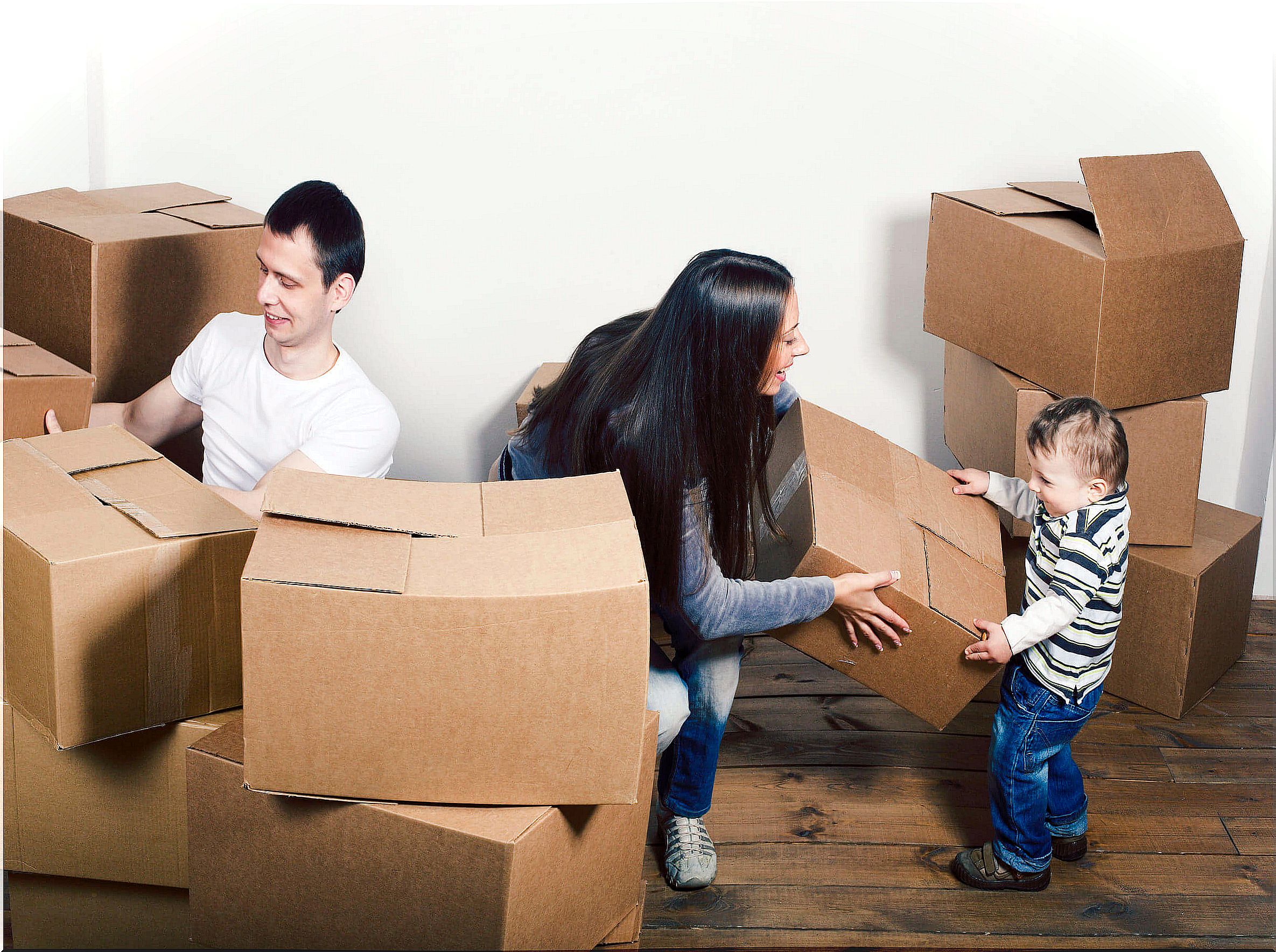 Child playing with a cardboard box on the move.