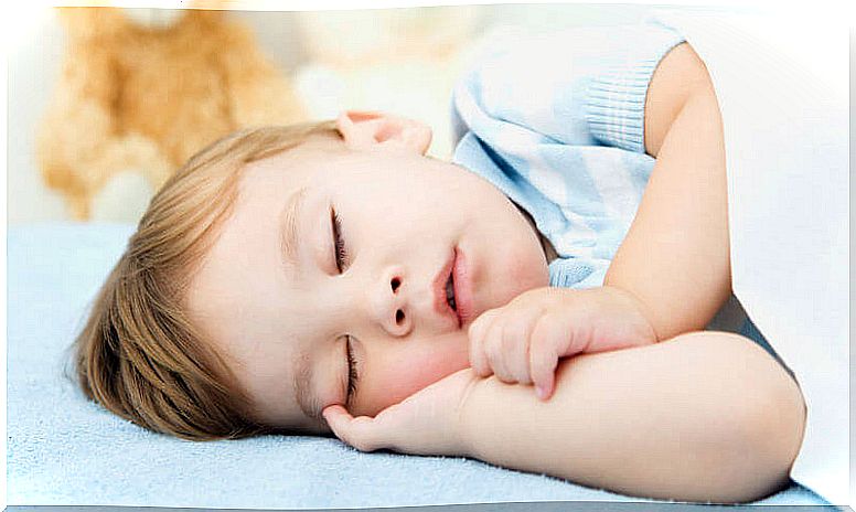 Boy sleeping with blue t-shirt