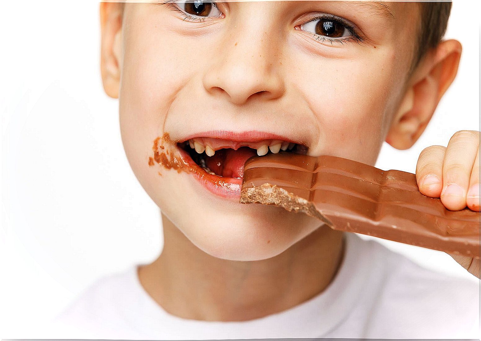 Child eating a chocolate bar.